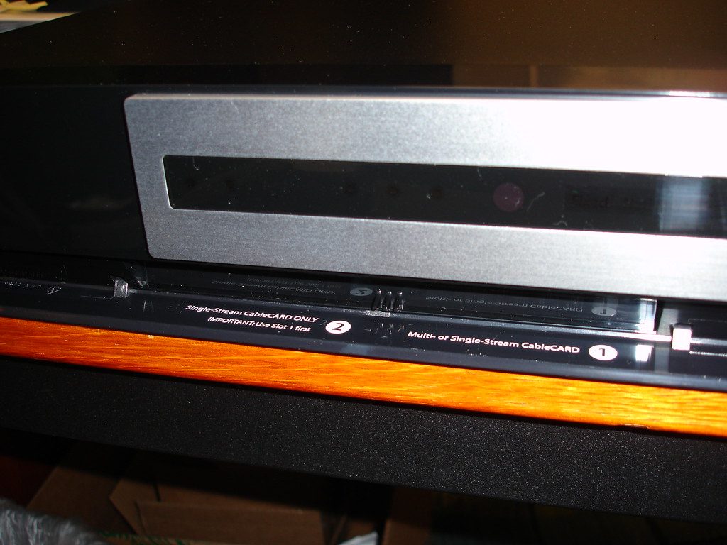 Dorm bedside caddy with charging-cable slots