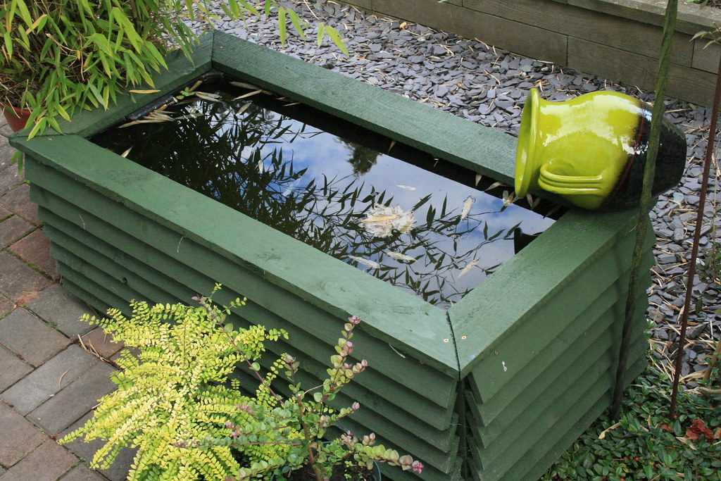 Hose nozzle hanging storage cradle
